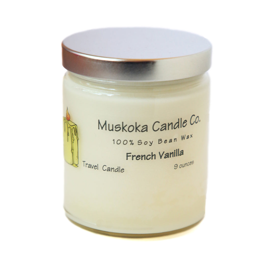 a white candle in a glass container with lid.