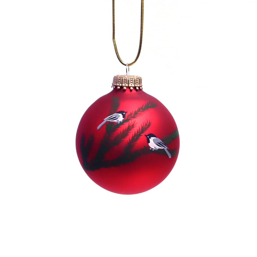 red hand-painted glass ornament featuring birds on a branch