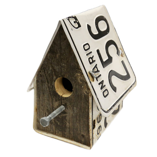 Birdhouse made from vintage black and white Ontario license plates and weathered brown barn wood