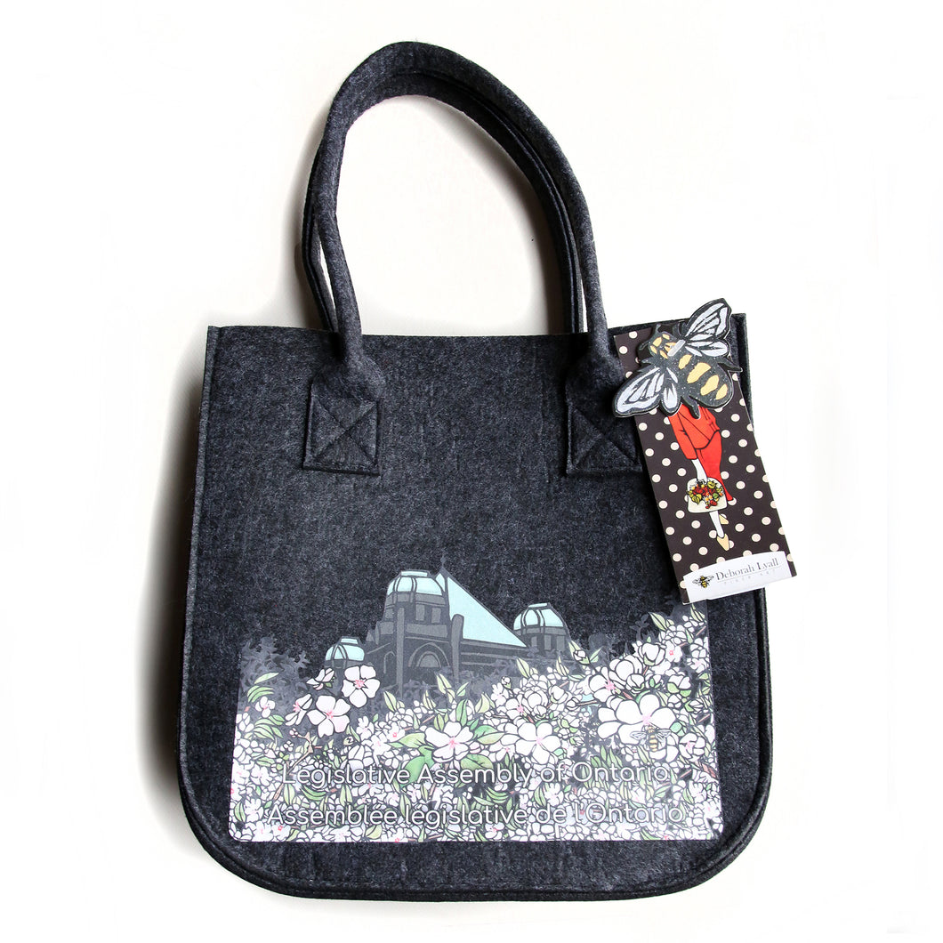black felt lunch bag featuring imagery of Japanese cherry blossoms in front of the legislative building.