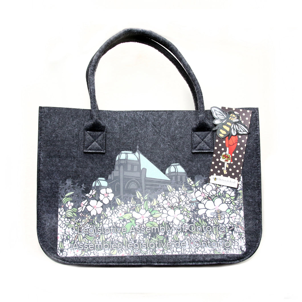 black felt tote bag featuring imagery of Japanese cherry blossoms in front of the legislative building.