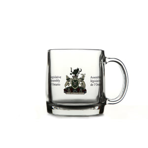 Clear glass mug with Legislative Assembly coat of arms in colour and etched on front centre.