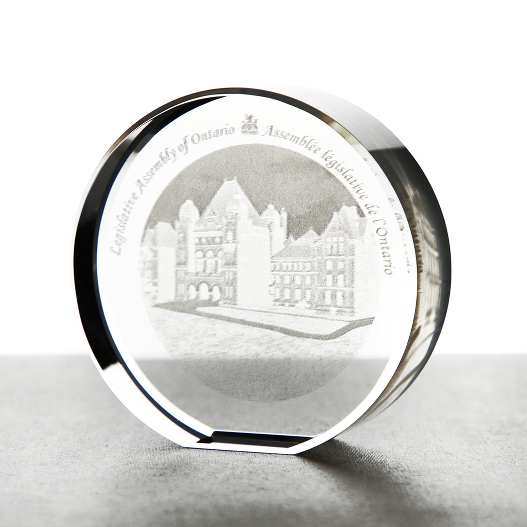 round crystal paper weight etched with 3D image of Legislative Assembly building