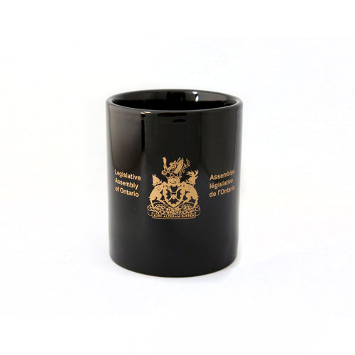 black mug etched with Legislative Assembly coat of arms in gold