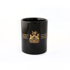 black mug etched with Legislative Assembly coat of arms in gold