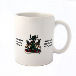white mug with the Legislative Assembly coat of arms etched in colour.