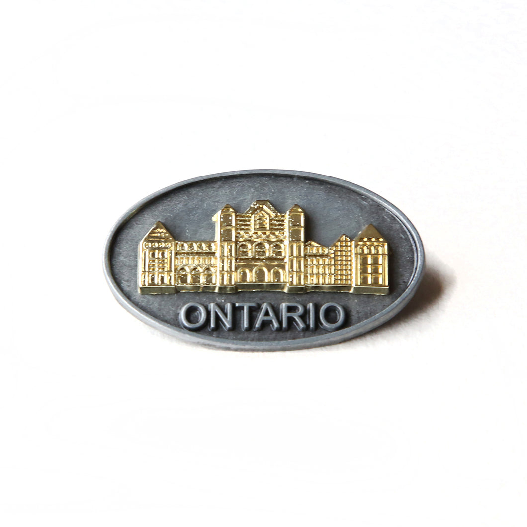 Oval pewter pin with gold coloured insert of the Legislative Building 