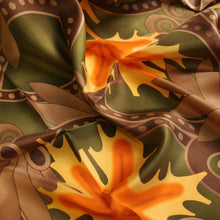 Load image into Gallery viewer, Silk scarf featuring maple leaf artwork in green, orange, yellow and brown from the Legislative Chamber ceiling