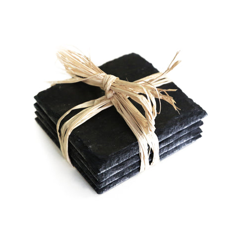 set of four square slate coasters wrapped in a straw bow