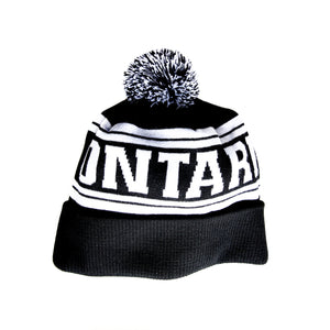 Black and white knit toque with the word Ontario woven into the fabric in white