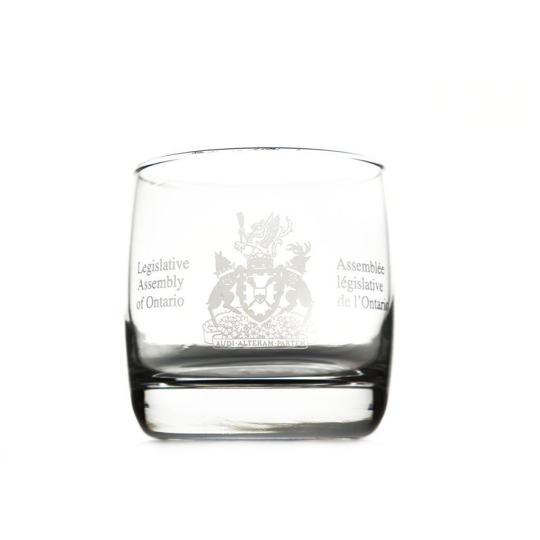 Whiskey glass etched with the Legislative Assembly coat of arms etched on the centre of the glass.
